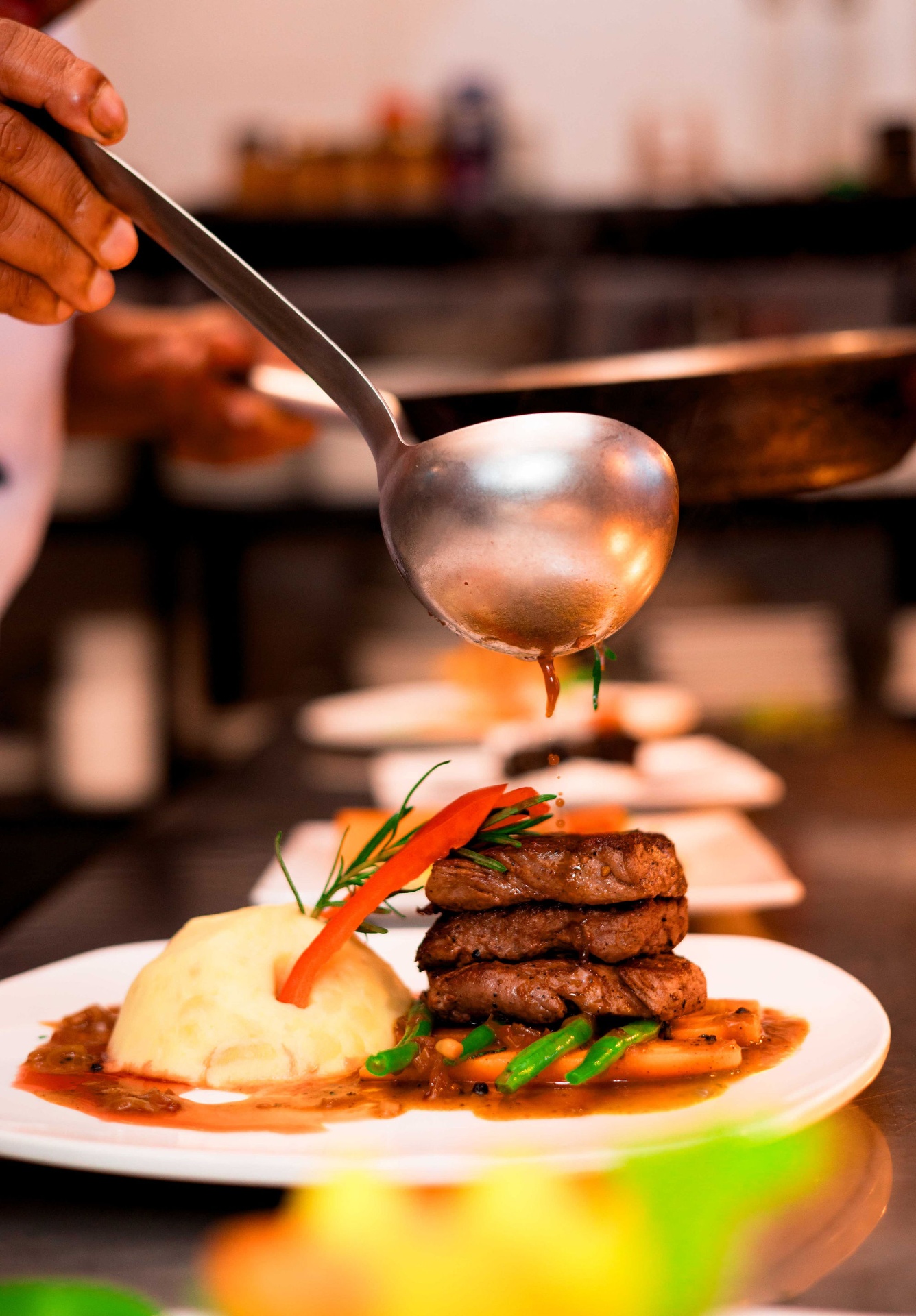 Chef plating an open-fire dish at Mtoni River Lodge